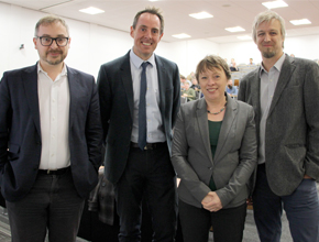 maria eagle posing for photo with three gentlemen